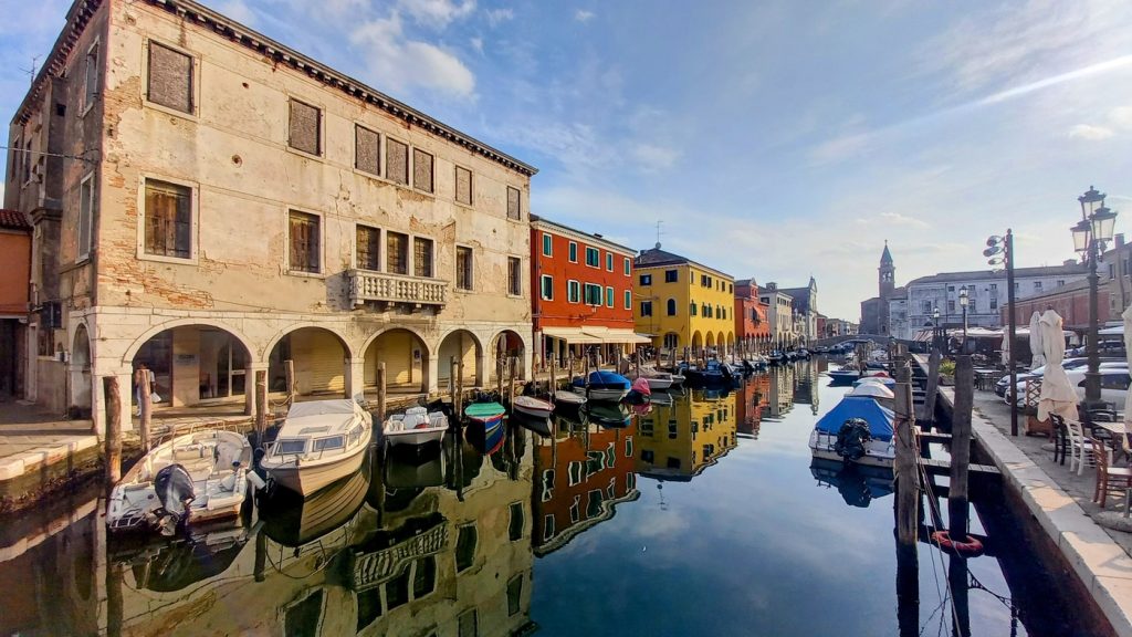 Chioggia canal with colourful houses on the Venice to Florence cycling tour
