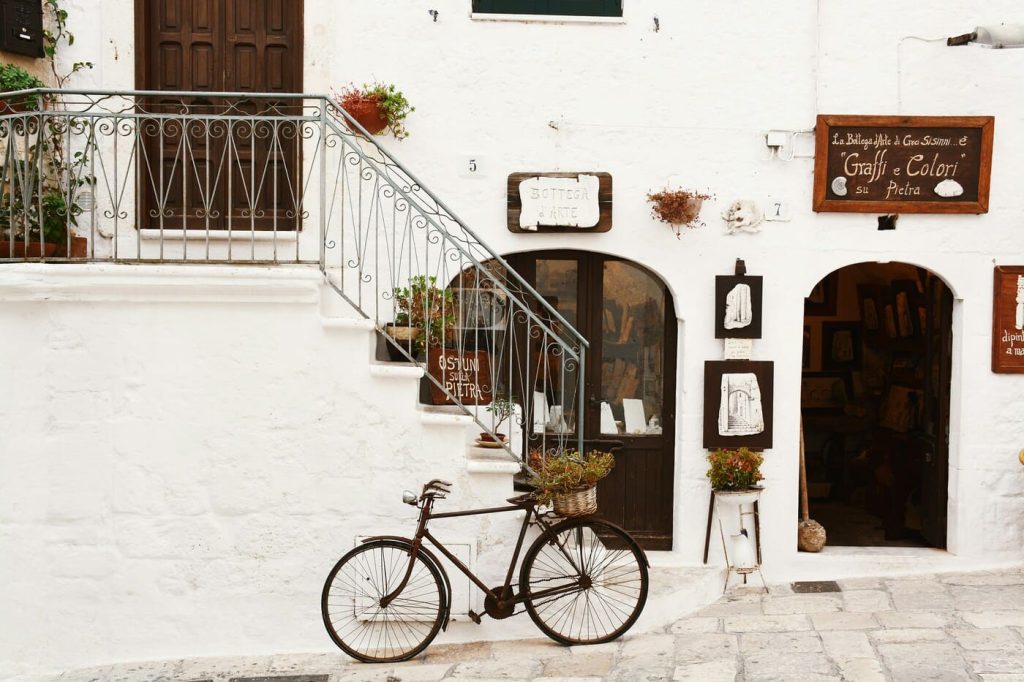 Vintage bicycle outside an artisan shop on a Mediterranean cycling escape